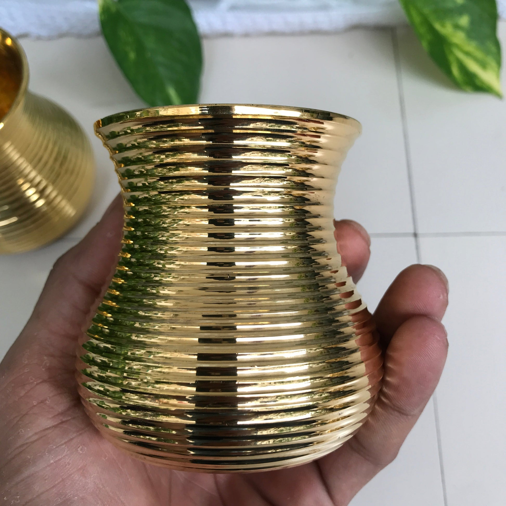 Eco-friendly and elegant Damru tumblers in brass for Indian-style dining.