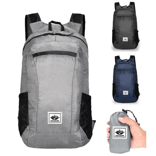 Gray backpack with black accents, shown open and folded, on a white background.