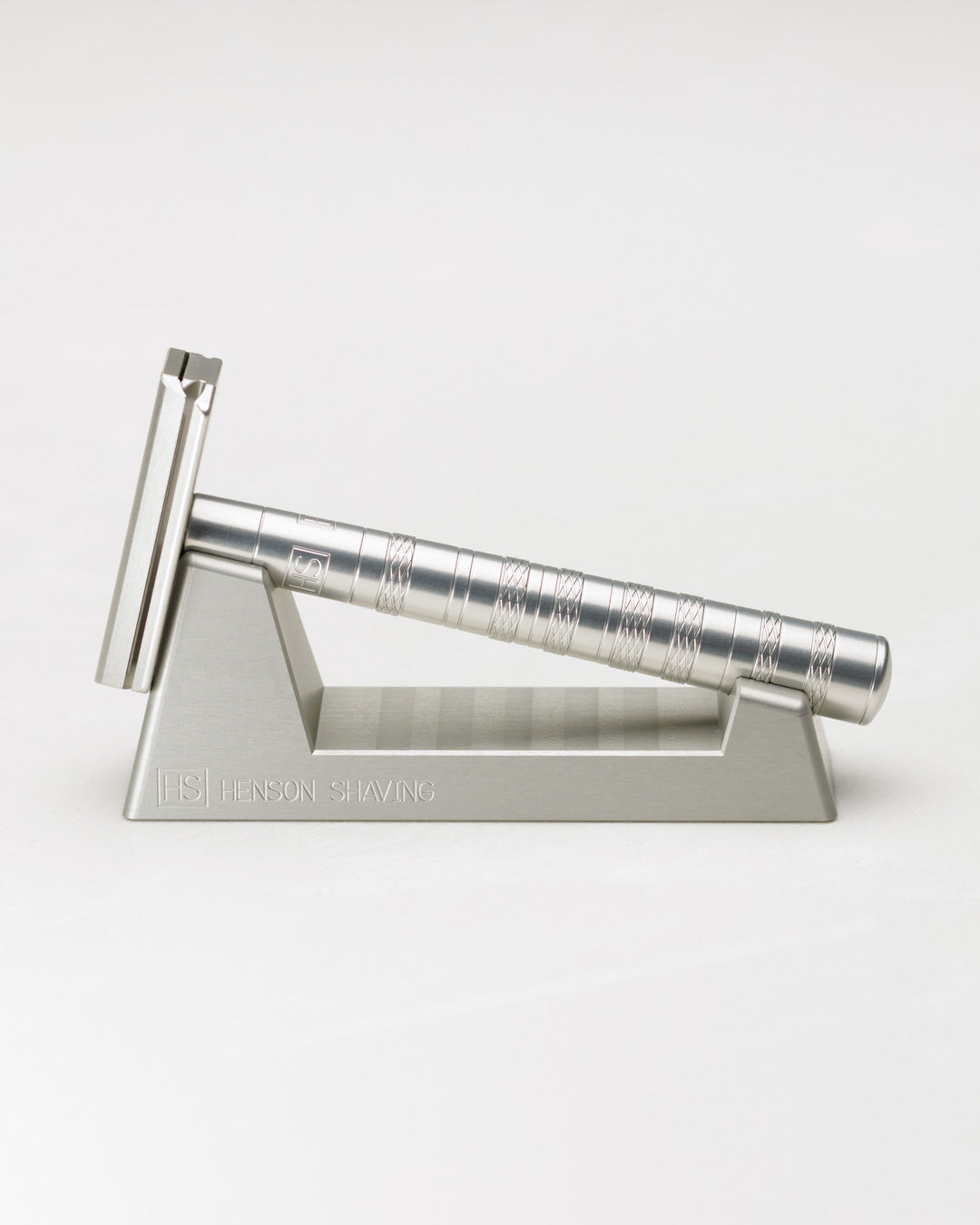 Silver safety razor on a stand with 'Erbe' branding against a white background